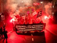 U.S. Flags Torched And Fires Set As Demonstrators Confront Trump Ahead Of Davos Summit